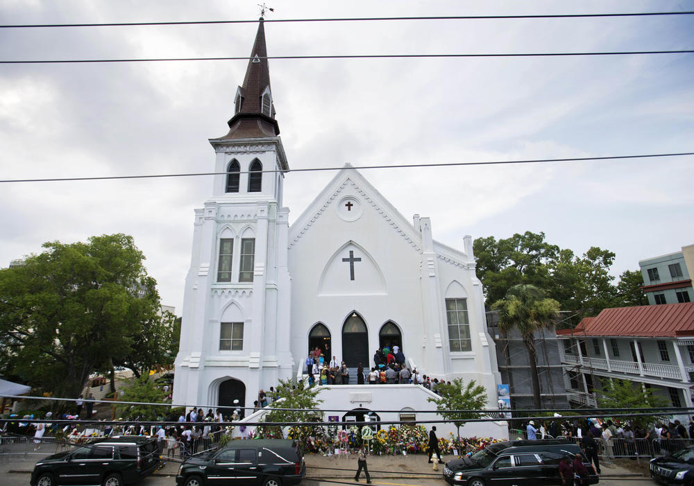 In this June 25, 2015, file photo, people line up to attend the wake of Sen. Clementa Pinckney, one of the nine killed in a shooting, at Emanuel AME Church in Charleston, S.C. 