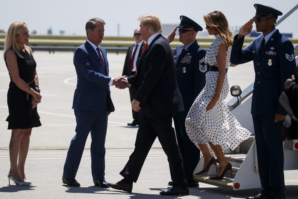 Gov. Brian Kemp and his wife Marty Kemp greet President Donald Trump and first lady Melania Trump as they arrive at Hartsfield-Jackson International Airport to attend the 