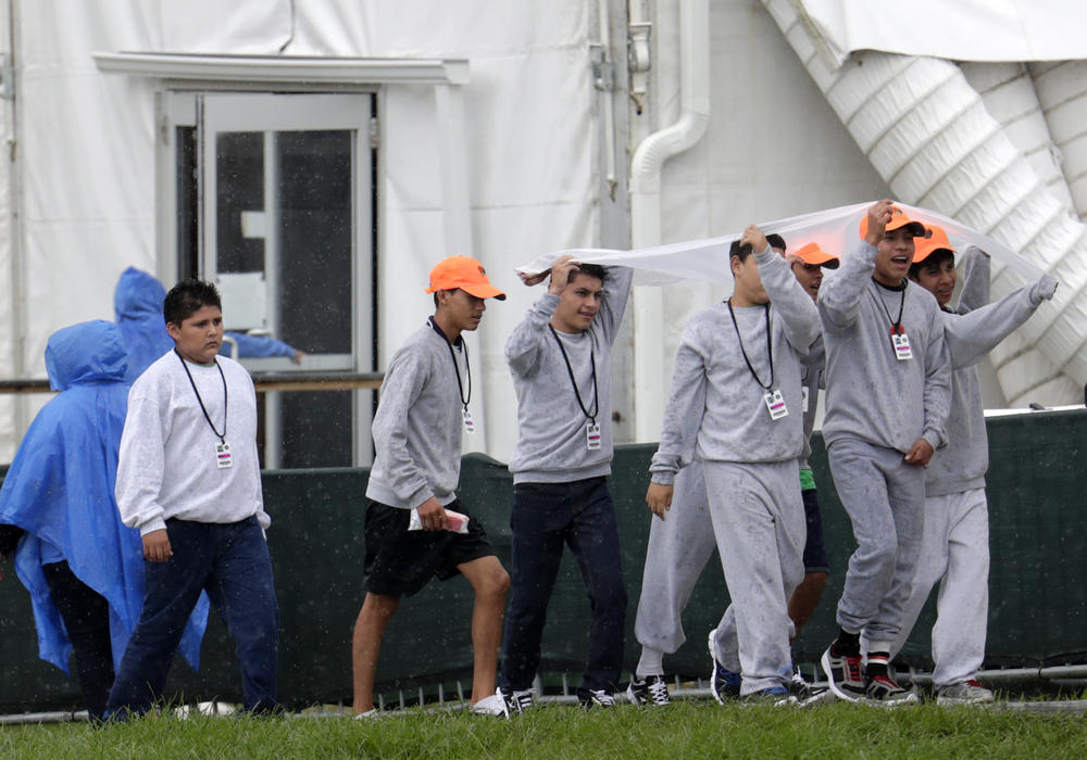 Migrant children walk on the grounds of the Homestead Temporary Shelter for Unaccompanied Children, Sunday, June 16, 2019, in Homestead, Fla. A coalition of religious groups and immigrant advocates said they want the Homestead detention center closed.