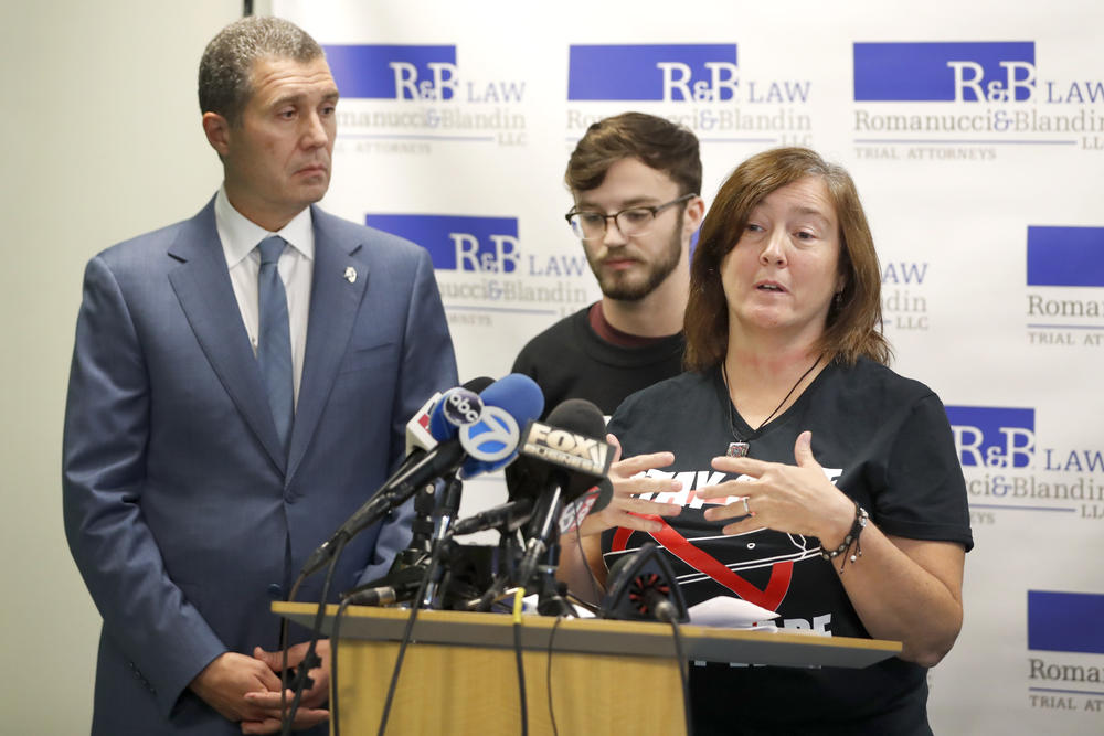Polly Hergenreder, right, and her son Adam, center attend a news conference where their attorney Antonio Romanucci, announced the filing of a civil lawsuit against e-cigarette maker Juul on Hergenreder's behalf Friday, Sept. 13, 2019, in Chicago.