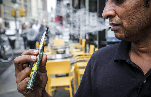 Inam Rehman, manager of Jubilee Vape & Smoke Inc., vapes while discussing New York Gov. Andrew Cuomo's push to enact a statewide ban on the sale of flavored e-cigarettes amid growing health concerns, Monday Sept. 16, 2019, in New York.