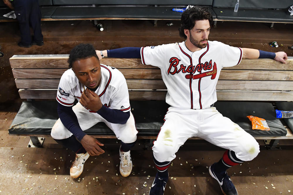 Atlanta Braves' Dansby Swanson, right, and Ozzie Albies sit in the dugout after the Braves lost 13-1 to the St. Louis Cardinals in Game 5 of their National League Division Series on Wednesday in Atlanta. 