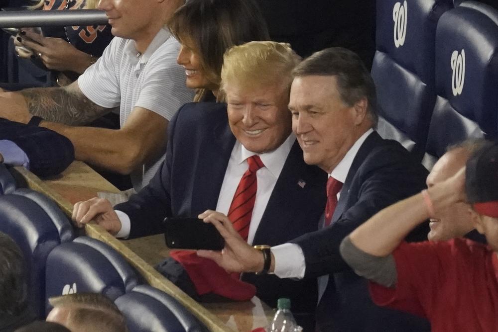 Sen. David Perdue, R-Ga., takes a selfie with President Donald Trump during the seventh inning of Game 5 of the baseball World Series on Sunday, Oct. 27, 2019, in Washington. 