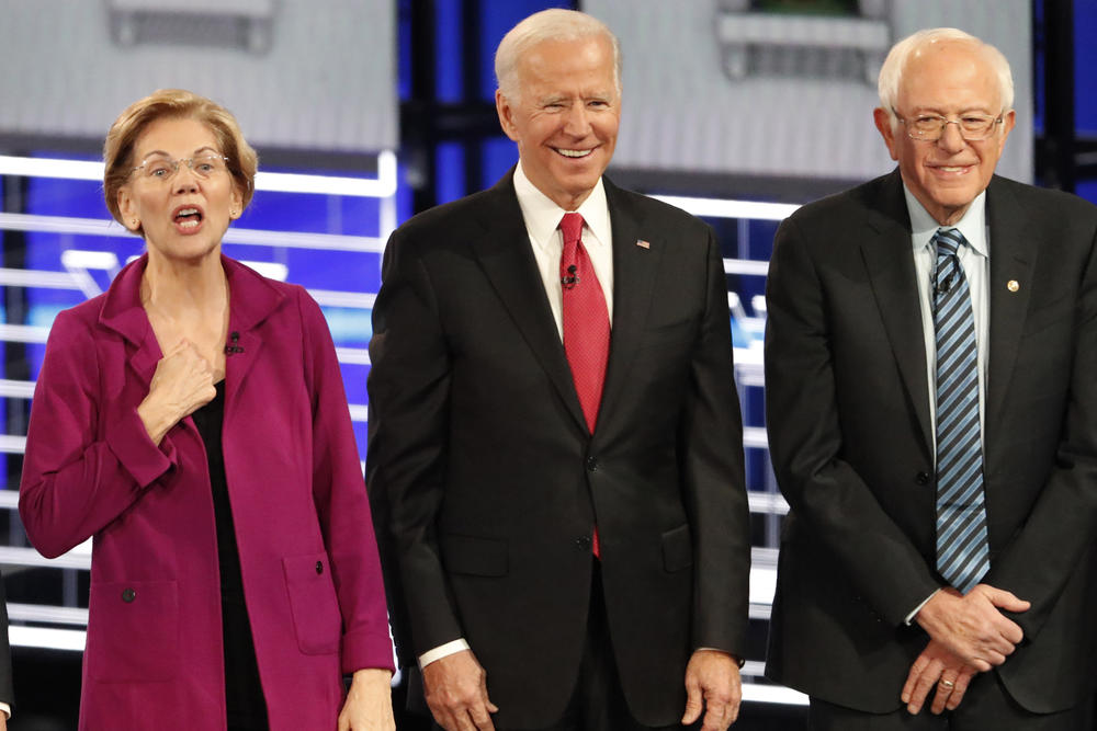 Democratic presidential candidates Sen. Elizabeth Warren, D-Mass., left, gestures as former Vice President Joe Biden, center, and Sen. Bernie Sanders, I-Vt., on the stage in Atlanta for the Democratic presidential debate on Wednesday, Nov. 20, 2019.