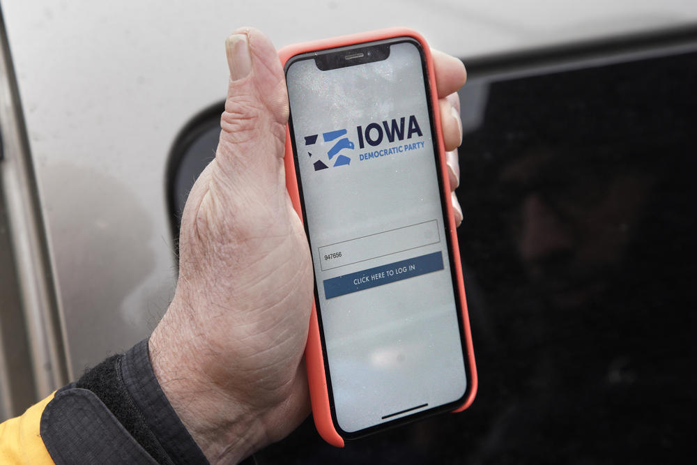 Precinct captain Carl Voss of Des Moines displays the Iowa Democratic Party caucus reporting app on his phone outside of the Iowa Democratic Party headquarters in Des Moines, Iowa, Tuesday, Feb. 4, 2020.