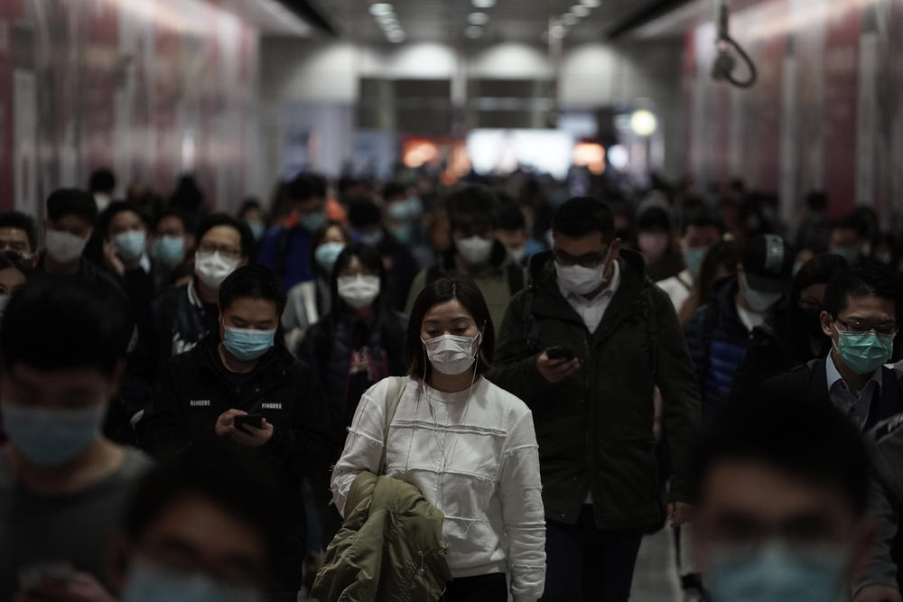 People wearing masks, walk in a subway station, in Hong Kong, Friday, Feb. 7, 2020. Hong Kong on Friday confirmed 25 cases of a new virus that originated in the Chinese province of Hubei. According to the latest figures, 233 new cases of the novel coronav