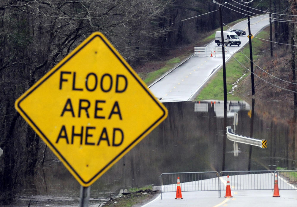 Vehicles turn around on a road blocked by floodwaters in Helena, Ala., on Tuesday, Feb. 11, 2020. 
