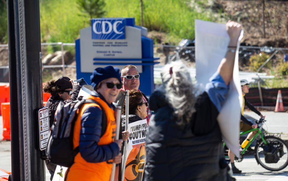 Protestors demonstrate in front of the Centers for Disease Control and Prevention headquarters on Friday, March 6, 2020 in Atlanta.