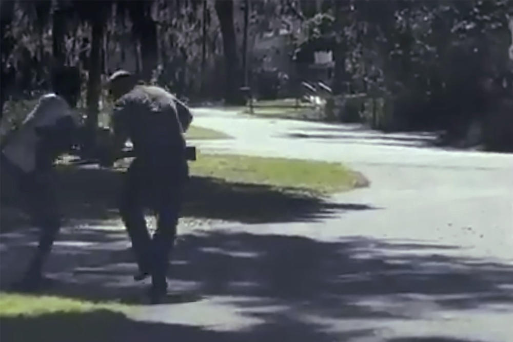 This image from video posted on Twitter Tuesday, May 5, 2020, purports to show Ahmaud Arbery, left, struggling with Travis McMichael over a shotgun on a street in a neighborhood outside Brunswick, Ga., on Feb. 23, 2020.