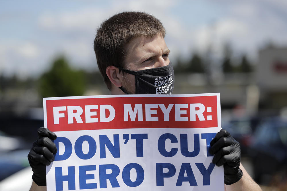 Sherman Jenne, a cashier at the Fred Meyer grocery store in Burien, Washington, takes part in a protest outside the store against Fred Meyer's parent company Kroger on Friday, May 15, 2020.