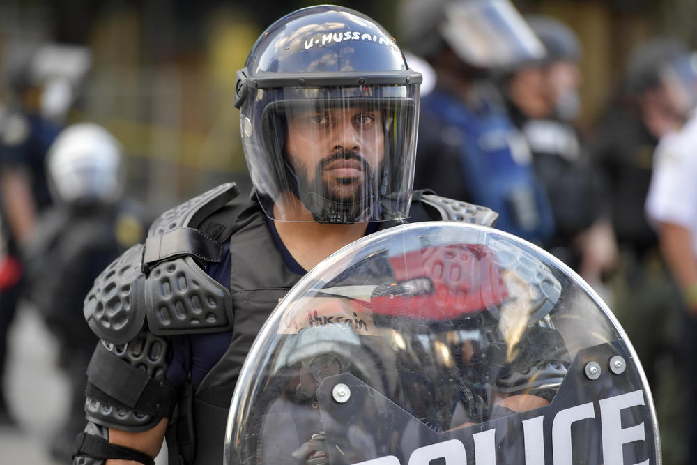 Atlanta Police monitor demonstrators protesting, Friday, May 30, 2020 in Atlanta. The protest started peacefully earlier in the day before demonstrators clashed with police.