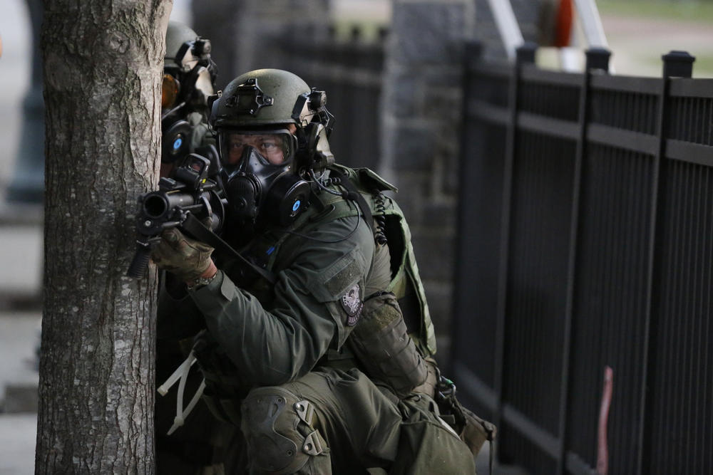 Police prepare to shoot gas as demonstrators march, Sunday, May 31, 2020, in Atlanta. Protests continued following the death of George Floyd, who died after being restrained by Minneapolis police officers on May 25.