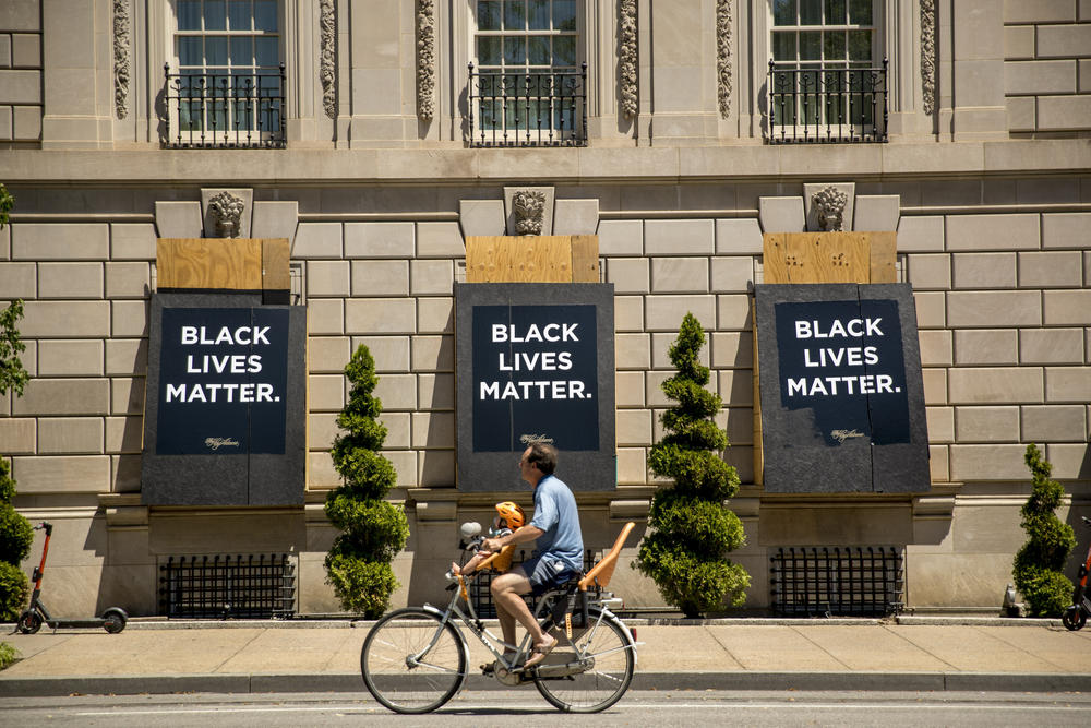 The words Black Lives Matter are painted on boarded up windows of the Hay Adams Hotel, a site of protests, near the White House in Washington.