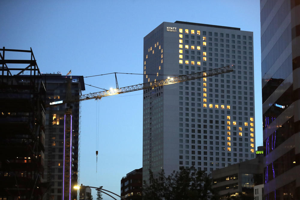 Lit windows at the Seattle Hyatt Regency Hotel display a heart and "BLM" for Black Lives Matter, Thursday, June 18, 2020, in downtown Seattle. 