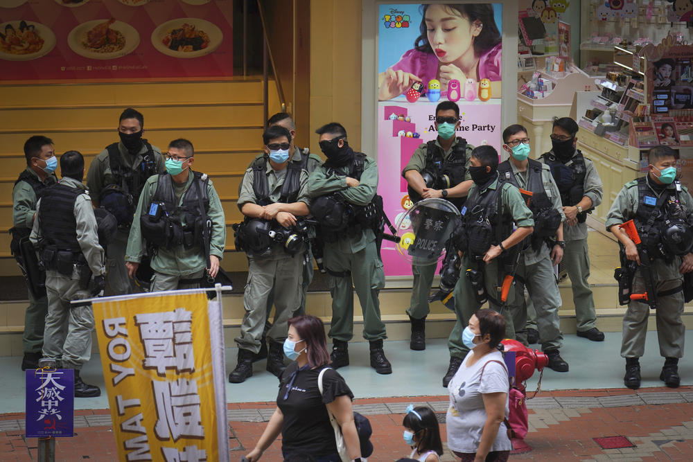 Police stand guard in Causeway Bay before the annual handover march in Hong Kong, Wednesday, July. 1, 2020. 