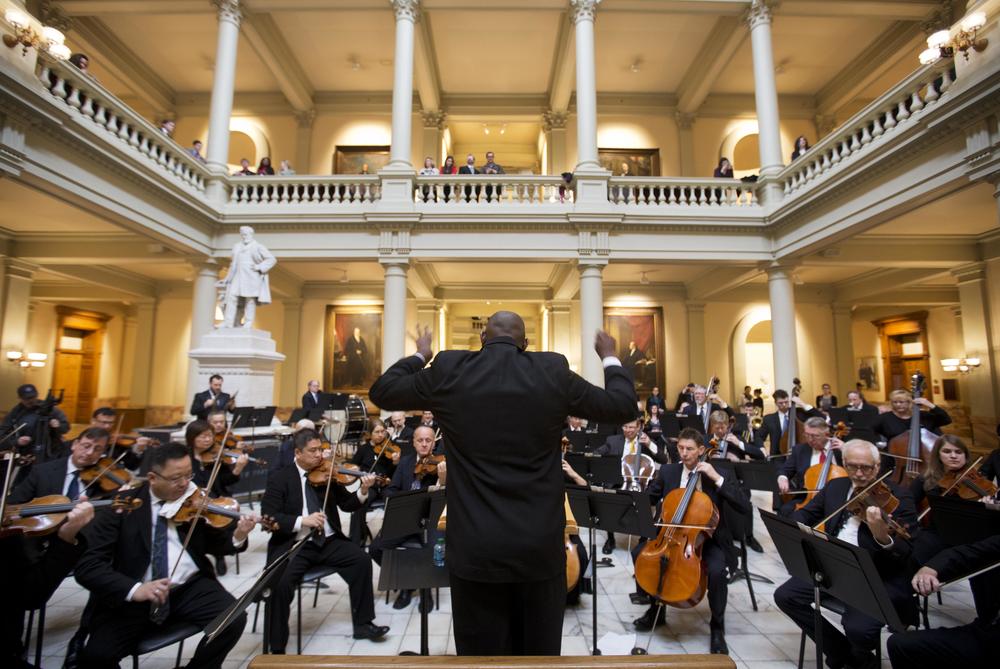 Conductor Joseph Young leads the Atlanta Symphony Orchestra in a performance at the state Capitol in Atlanta Tuesday, Jan. 13, 2015.