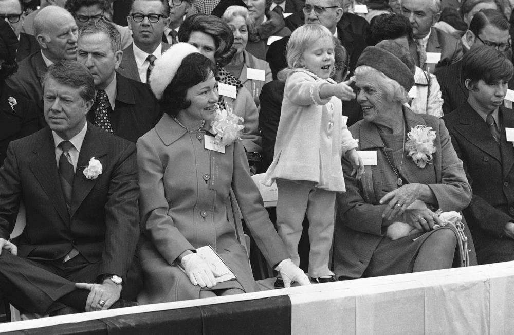 Gov. Jimmy Carter, left, Rosalynn Carter, daughter Amy Carter and mother Lillian Carter, right, listen while Lt. Gov. Lester Maddox makes his acceptance speech, Jan. 12, 1971, in Atlanta. Carter had just been sworn in as Governor of Georgia. 