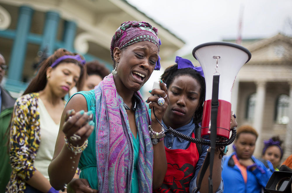 Omega Menders cries as she speaks to protesters demonstrating the shooting death of 27-year-old Anthony Hill by a police officer, Wednesday, March 11, 2015, in Decatur, Ga. Robert Olsen faces prison time when he is sentenced on four charges Nov. 1, 2019.