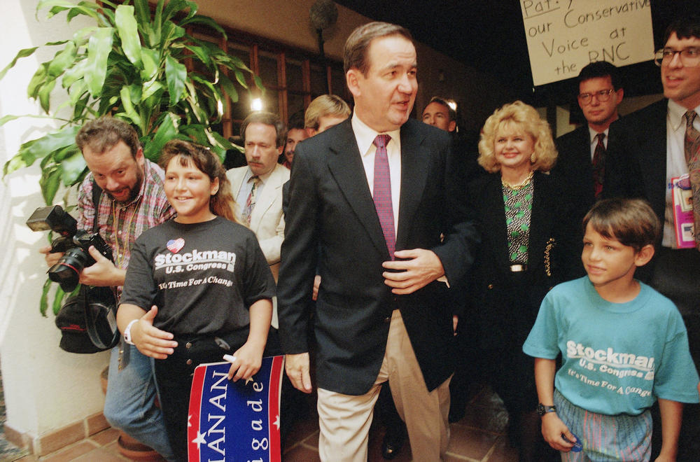 Conservative Republican Pat Buchanan, center, arrives in Houston for the 1992 Republican National Convention. There, he will deliver a defining speech in the history of the modern conservative movement.