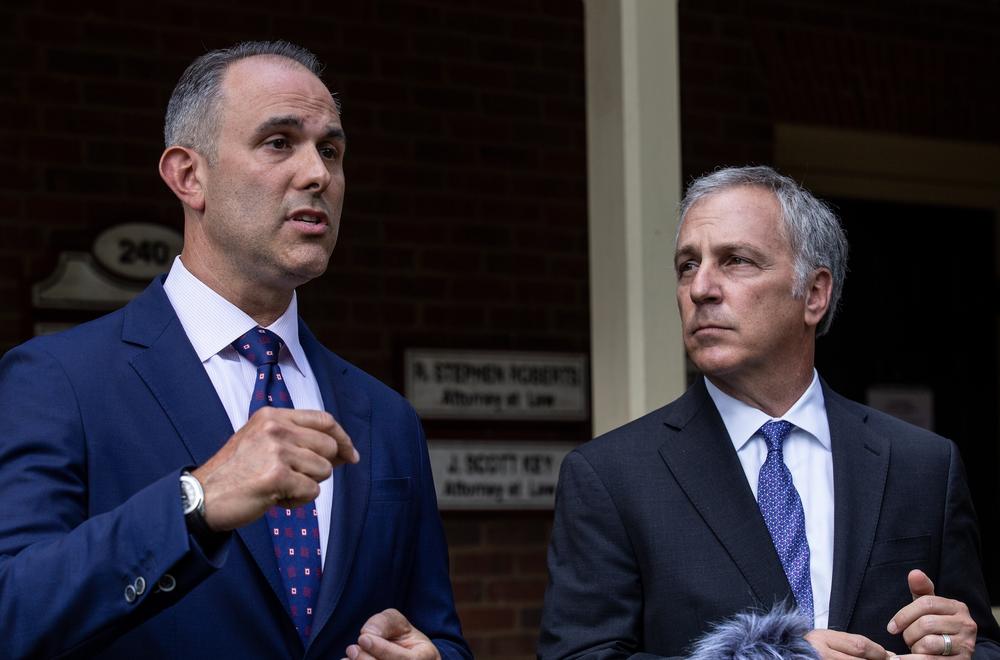 Attorney Jason Sheffield (left) and his law firm partner, Robert Rubin, respond to questions from the press outside their office on Thursday, May 14, 2020, in Decatur, Georgia.