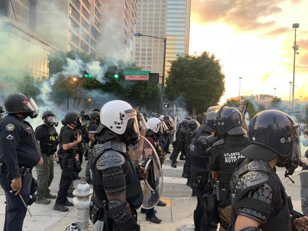 Police watch protesters in downtown Atlanta, Saturday, May 30, 2020, in Atlanta. The protesters were demonstrating against the the killing of George Floyd by police in Minnesota which has sparked worldwide protests and rioting nationwide. 