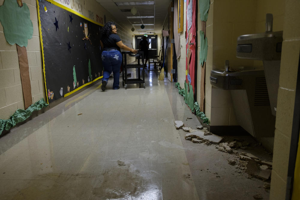 Pre-kindergarten teacher Jessica Beard looks back at some of the damage made by Hurricane Michael to the hall where she has her class at Potter Street Elementary School in Bainbridge. Students in Decatur County missed a week of school because of the storm.