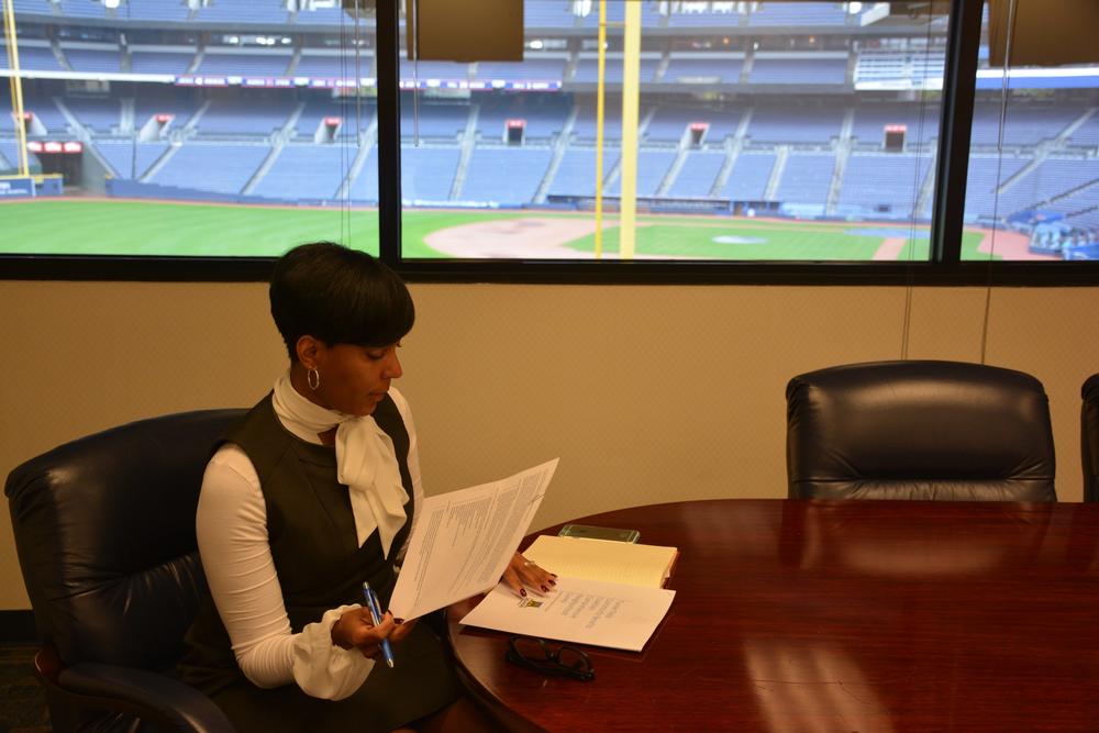 Keisha Lance Bottoms looking over paperwork in her office in Turner Field.