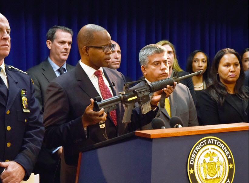 Brooklyn District Attorney Ken Thompson holds up one of the weapons seized from a gun trafficking operation that originated in Atlanta, Georgia, and Pittsburgh, Pennsylvania, and ended on the streets of Brooklyn.