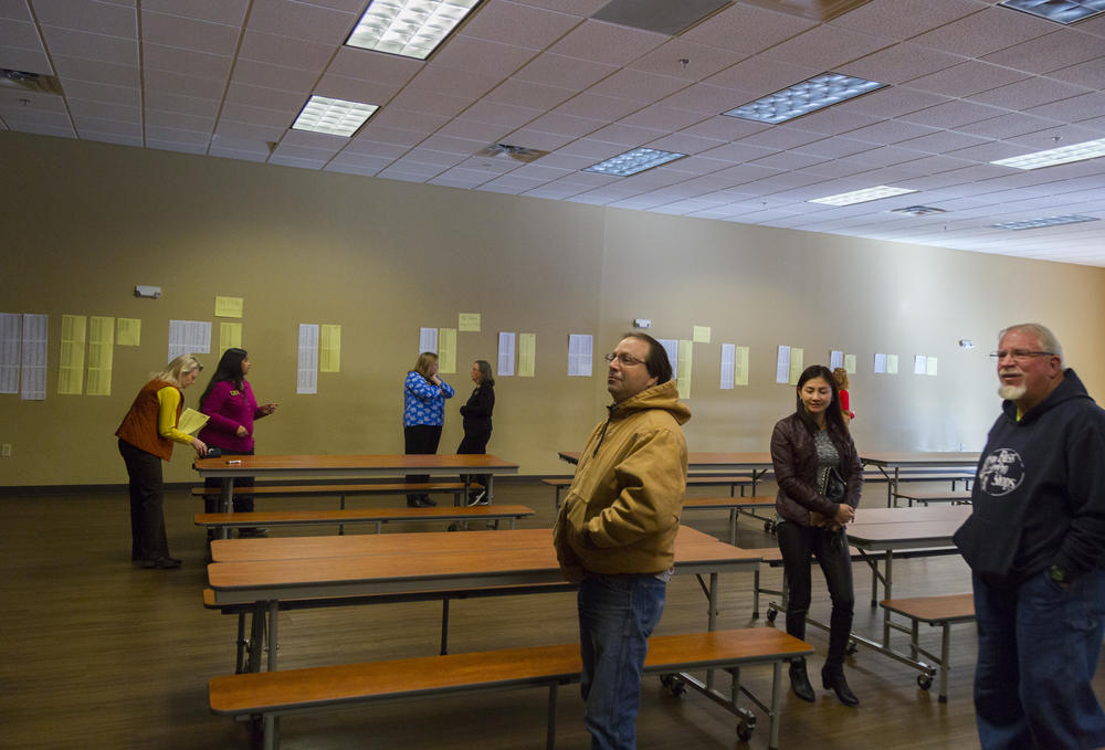 The results of the annual admissions lottery are posted on the wall of the cafeteria at the Academy for Classical Education while parents wait for weighting list results this past February. 