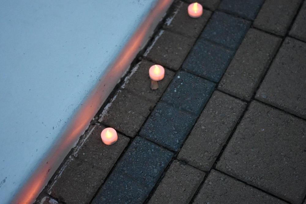 Tealights line the fountain at the Georgia Tech Campanile. Hundreds of community members attended a vigil for slain student Scout Schultz.