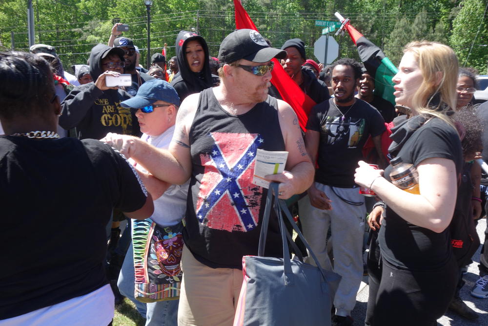 Black Lives Matter protestors confront a pair of Confederate supporters.