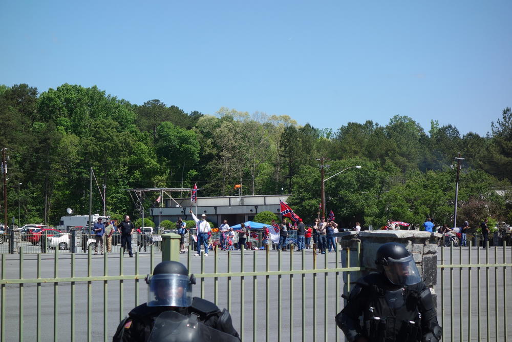 Police surround the fenced in Confederate rally.