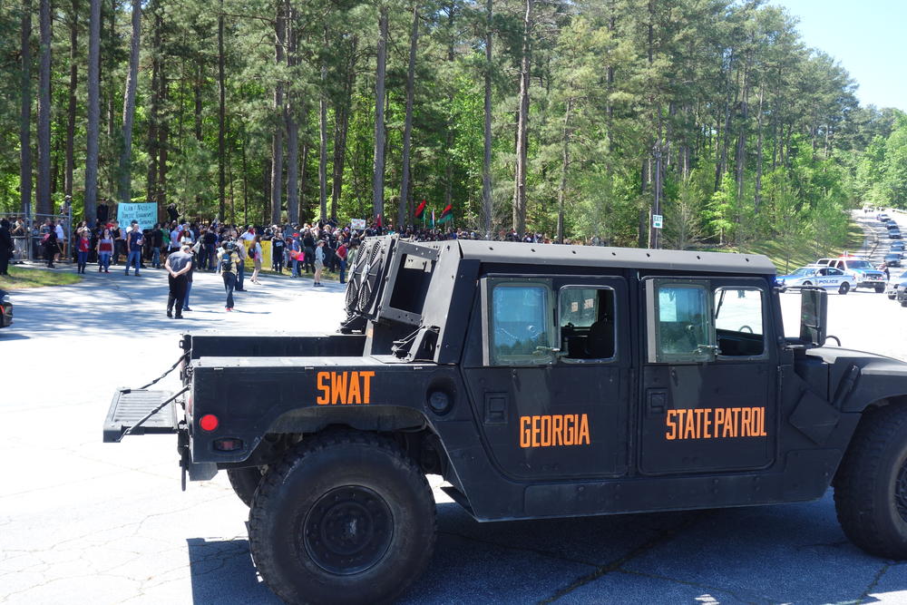 SWAT teams hold back counter-protesters.