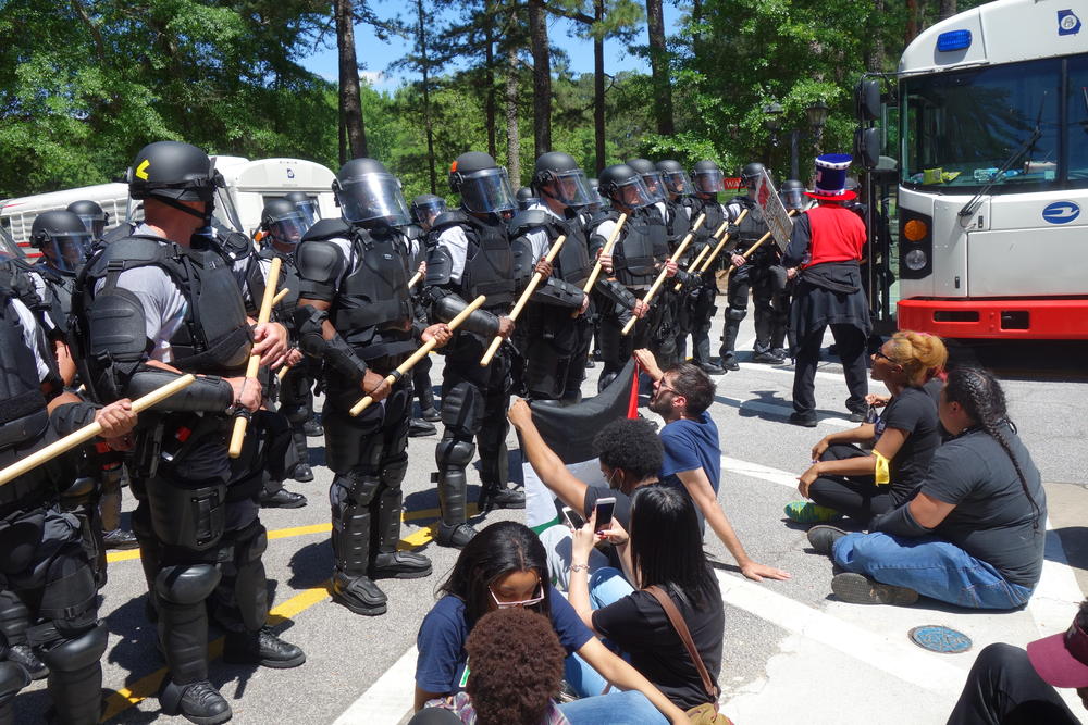 Police block anti-Confederate rally protestors.