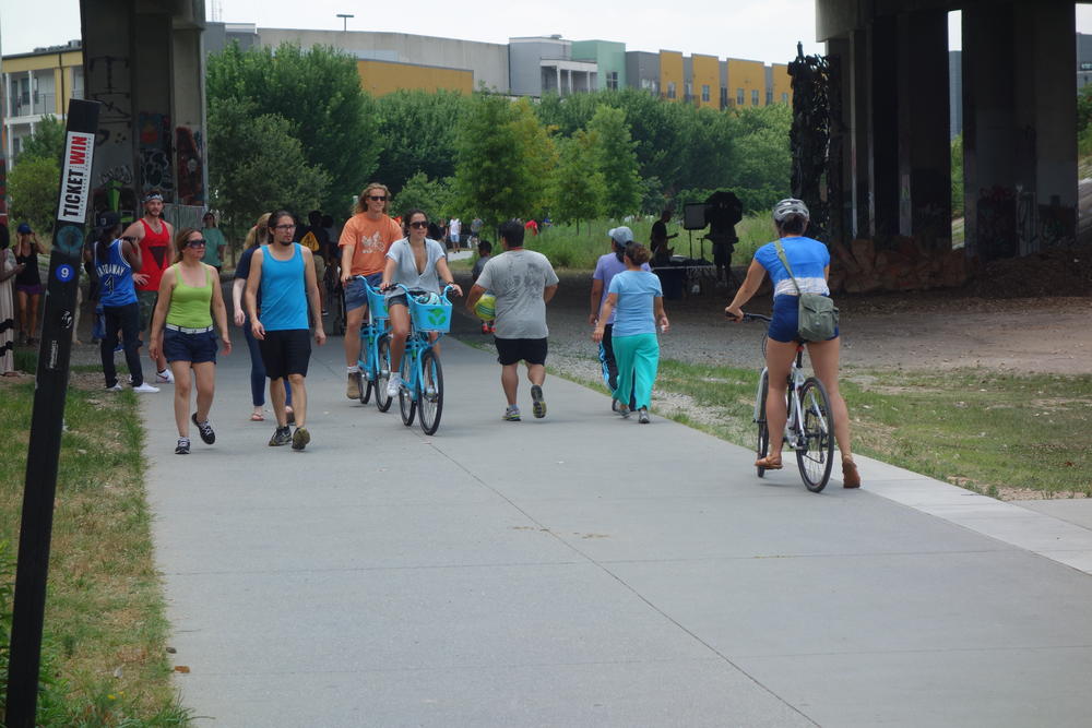 A packed, 14-foot wide trail accommodates two lanes of traffic at various speeds.