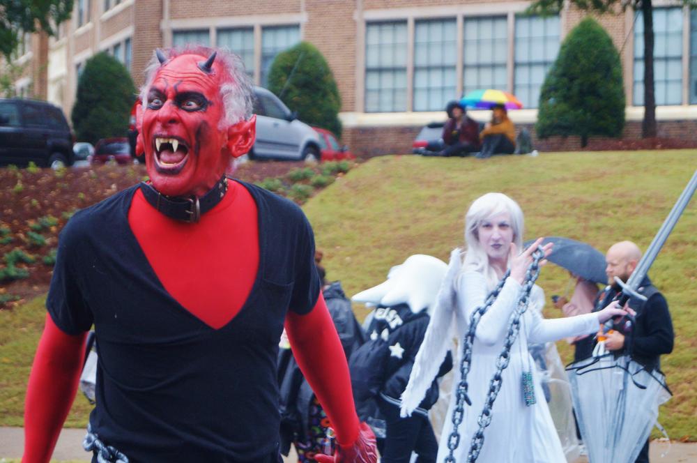 A parade participant in a devilish costume taunted the crowd.