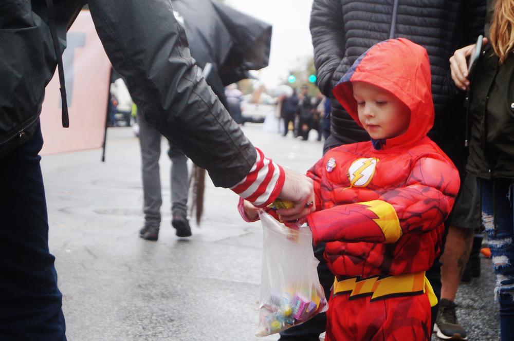 A boy received candy at the Halloween parade in Little 5 Points.