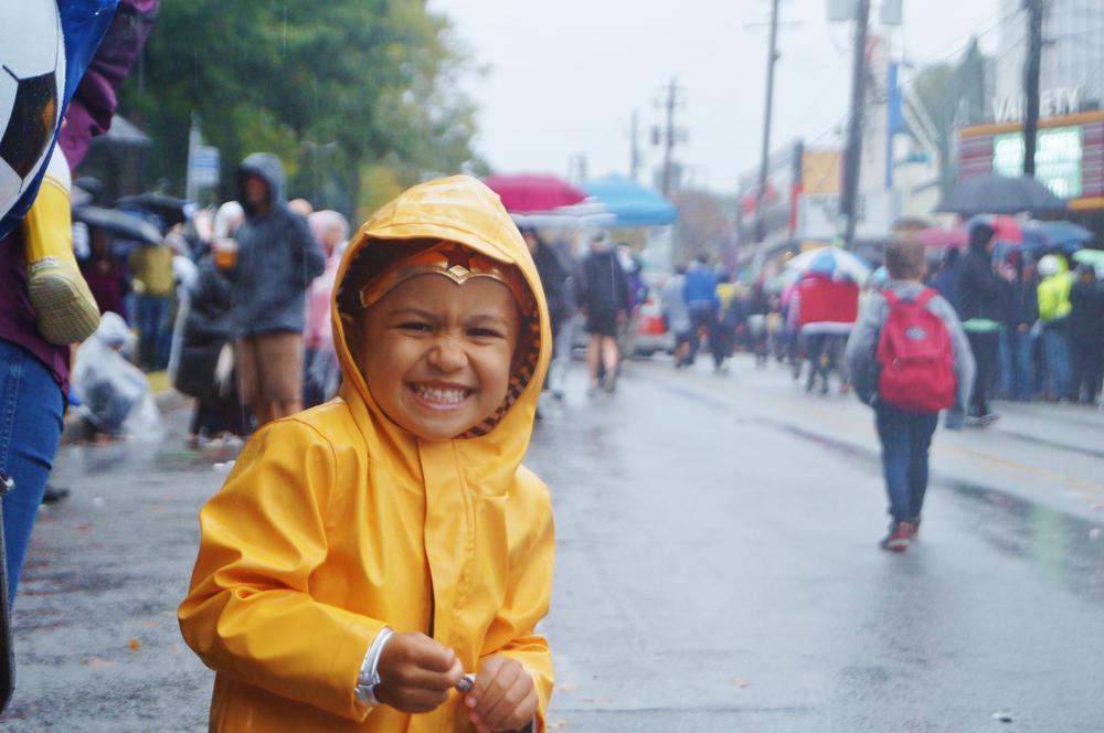 A girl smiled as she watched the parade.