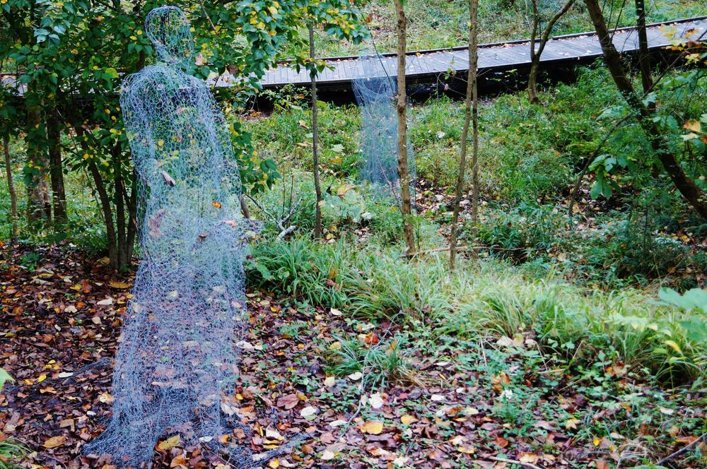 Two ghostly figures installed in the Fernbank Forest.