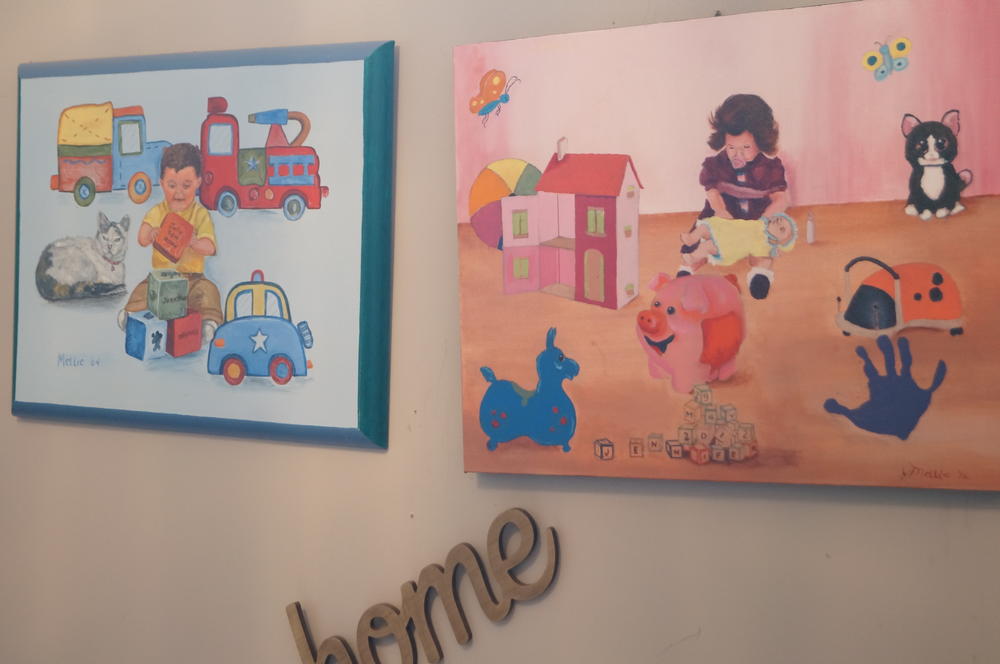 Paintings of Elizabeth Sherwood's two children as babies hang above the front door.