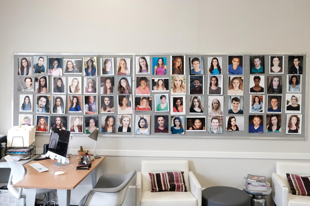 Student headshots cover a wall in SCAD's casting office.