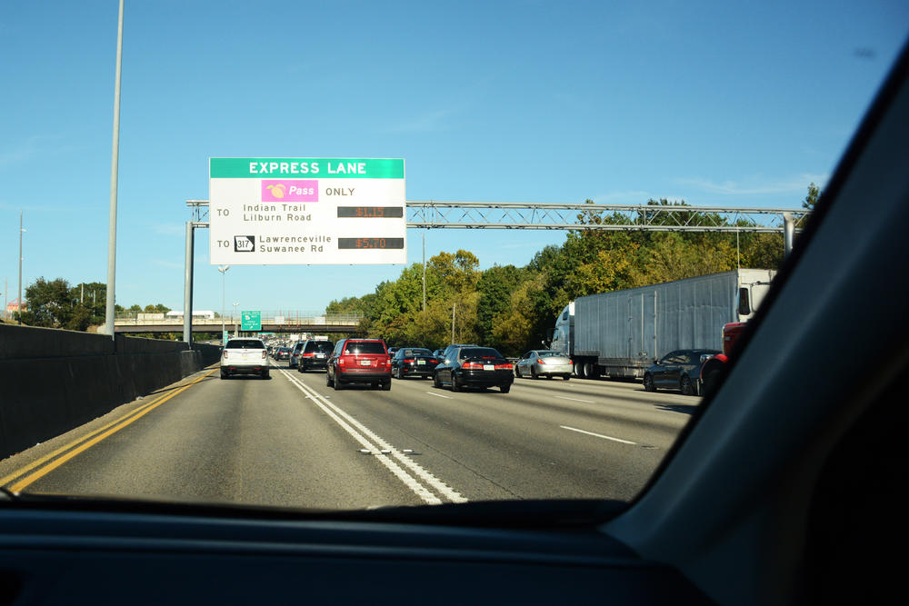 Signs above I-85 display the express lane's toll current toll rates during a Monday rush hour. The lanes were opened in 2011, and ridership has increased ever since.
