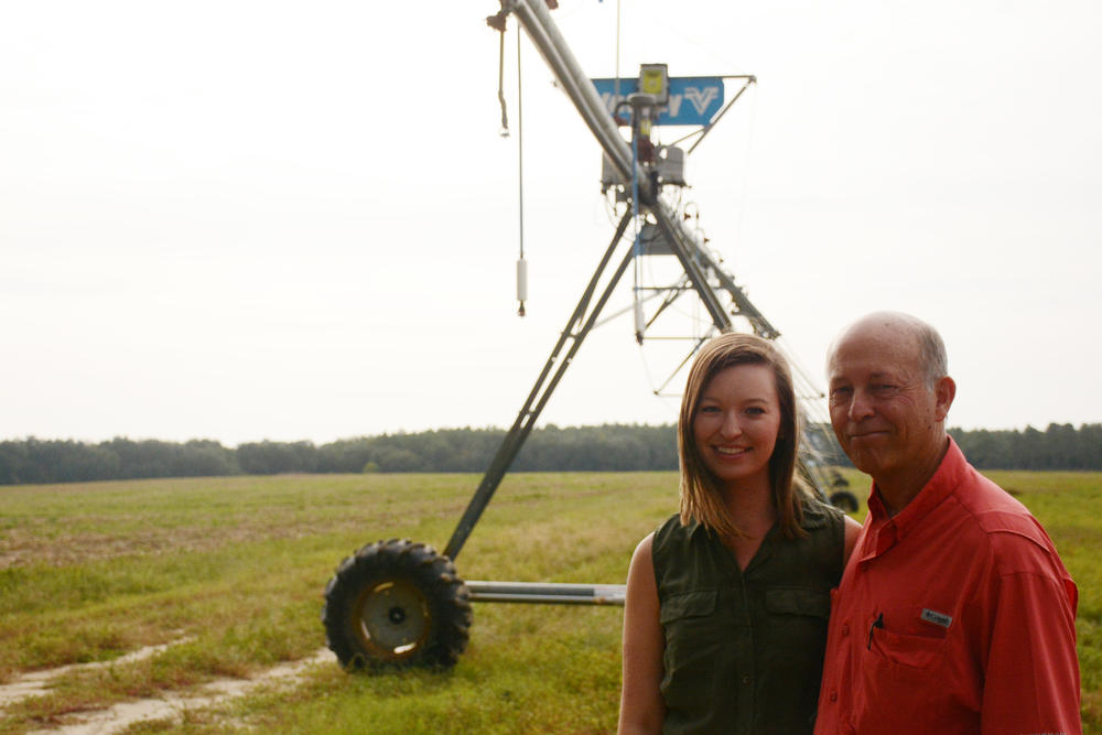Casey Cox and her father, Glenn, showing off one of their center-pivot irrigators equipped with a water-saving variable rate irrigation system.