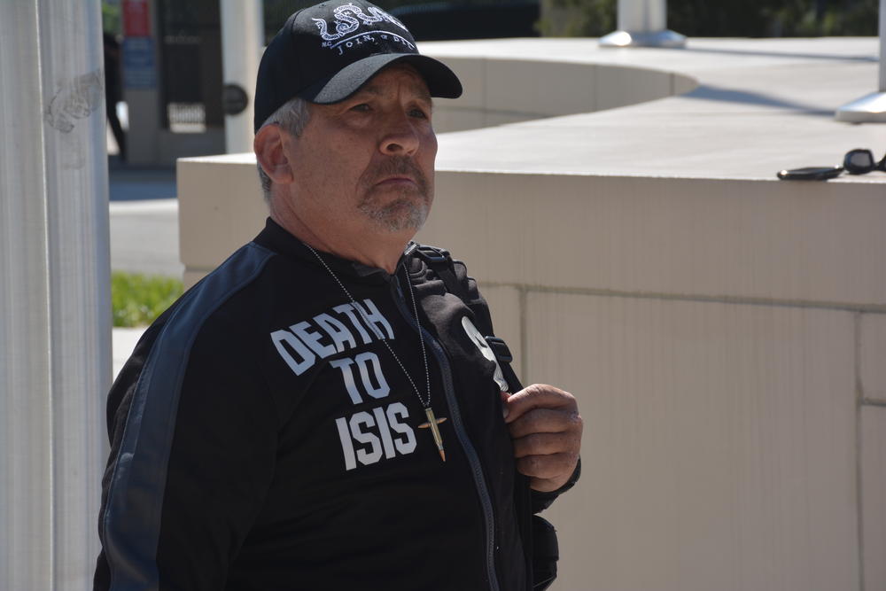 James Stachowiak stands, armed, for the rally across the street from the Capitol.