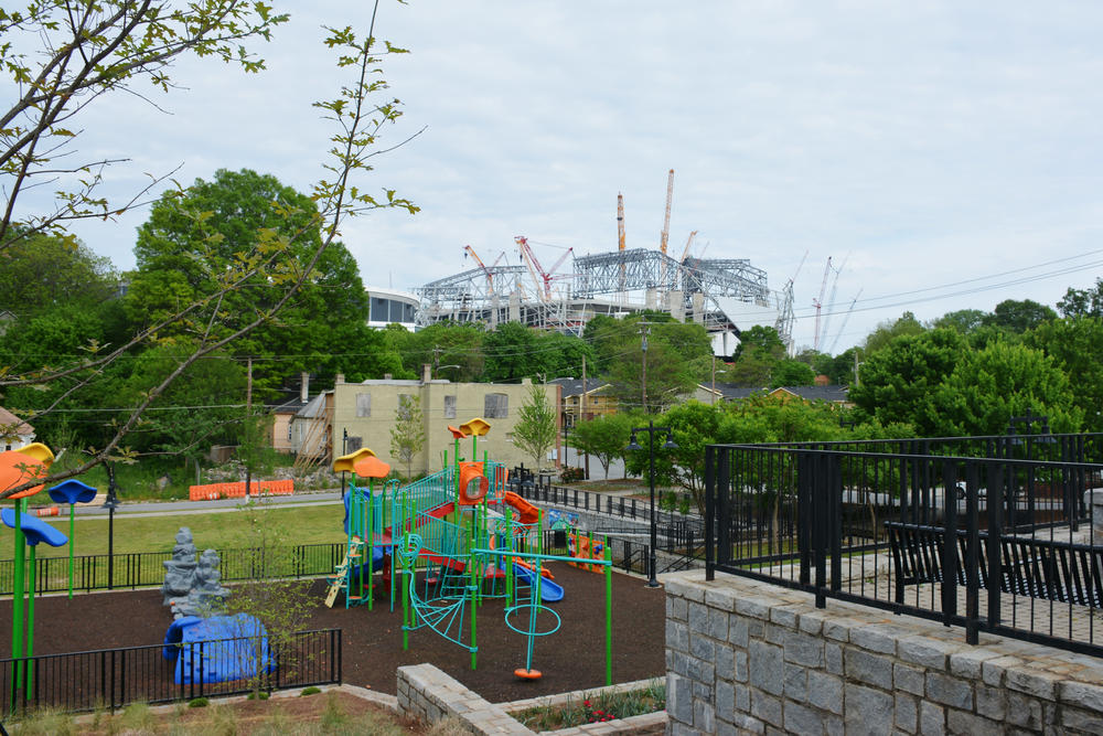 Mercedes-Benz Stadium rising over the recently completed Vine City Park.