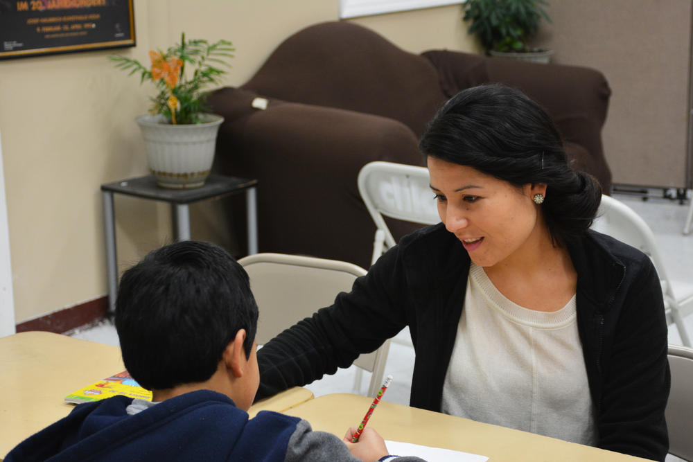 Sujey Guzman helping a local student with his homework. Guzman said many children from Dalton's Hispanic community worry what will happen to their parents under the Trump administration.