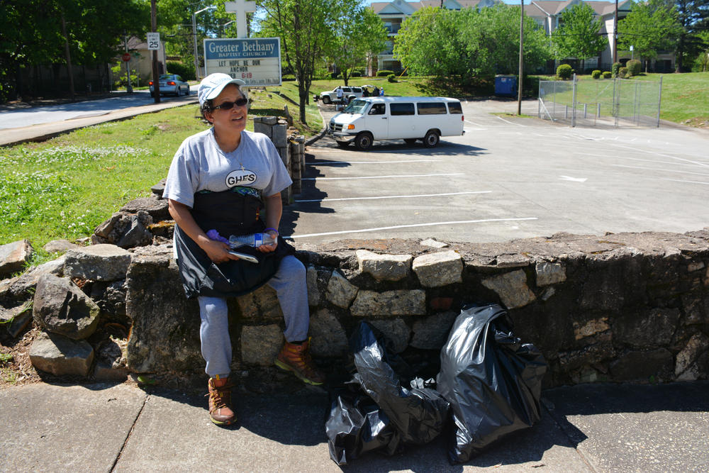 Rosario Hernandez takes a break after a community trash pickup.