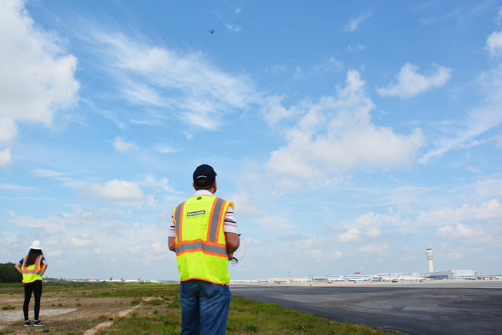 Katie Eleam acts as a spotter for pilot Jim Duguay, who has to fly the drone manually in the busy airspace around Hartsfield-Jackson.