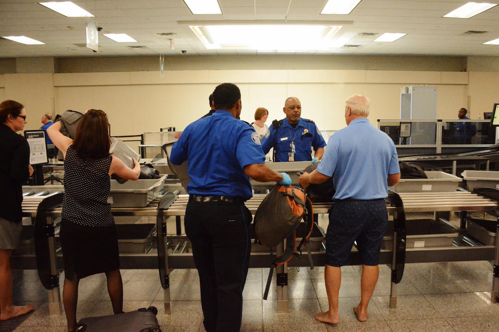 Travelers using the new security system at Hartsfield-Jackson Airport's south security checkpoint.