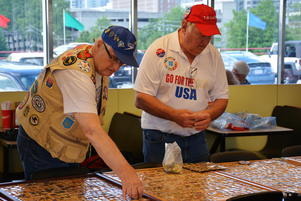 Ed Edwards (right) looking over his pin spread with another collector.